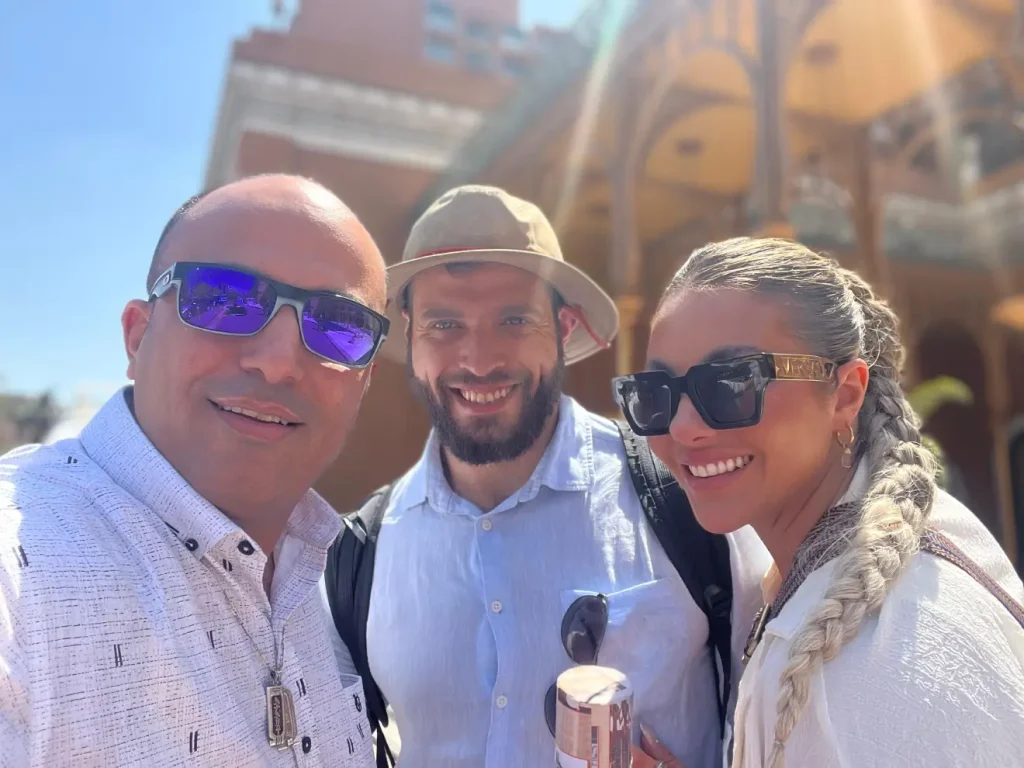Tourist couple walking with guide in Islamic Cairo alley