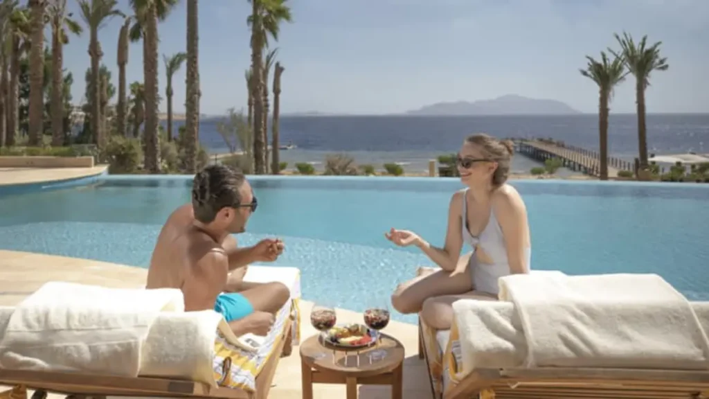 couple relaxing at luxury Red Sea resort infinity pool